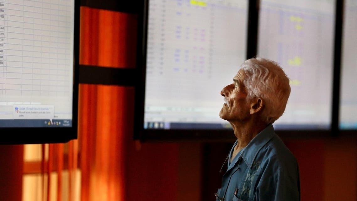 An Iraqi man checks shares prices at the Iraq Stock Exchange market in Baghdad, Tuesday, Aug. 19, 2014. (AP Photo/Hadi Mizban)