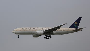 In this Thursday, April 16, 2015 photo, a passenger aircraft of the Saudi Arabian Airlines prepares for landing at the Indira Gandhi International Airport in New Delhi, India. (AP Photo/Altaf Qadri)