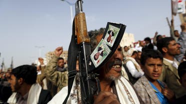 Houthi follower holds his rifle as he demonstrates against Saudi-led air strikes in Yemen's capital Sanaa