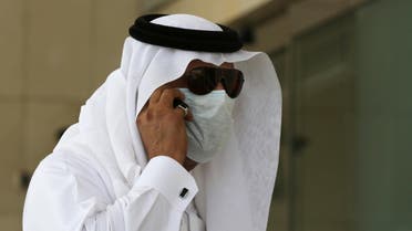 A Saudi man talks in his phone wears a mask outside King Fahd hospital in Jeddah, Saudi Arabia, Friday, May 9, 2014. Five more people have died in Saudi Arabia after contracting an often fatal Middle East respiratory virus as the number of new infections in the kingdom climbs higher, health officials confirmed Thursday. (AP Photo/Hasan Jamali)