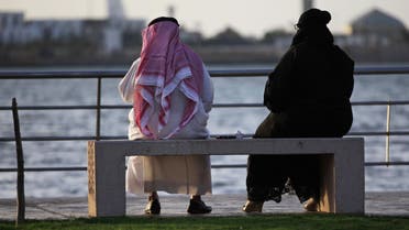 In this Sunday, May 11, 2014 photo, a Saudi couple sit on a bench overlooking the sea, in Jiddah, Saudi Arabia. A growing number of Saudi women are remaining single through their 20s and into their 30s as they pursue their ambitions, sending ultraconservatives into a panic. Traditionally, women in Saudi Arabia are expected to be married by their early twenties. Women are also challenging the rules on how to meet a prospective husband. (AP Photo/Hasan Jamali)