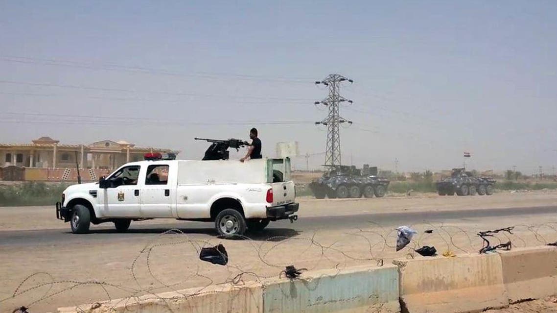 Arriving from Baghdad, federal police forces create a barricade to protect the Habaniyah military base near Ramadi, Iraq, in eastern Husaybah town, 8 kilometers (5 miles) east of Ramadi on Monday, May 18, 2015. AP