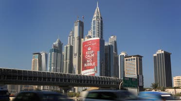this Wednesday Nov. 13, 2013 photo, vehicles pass by a tower with a sign that reads, "Keep Calm, No Bubble," at the Marina district in Dubai, United Arab Emirates. (File photo: AP)