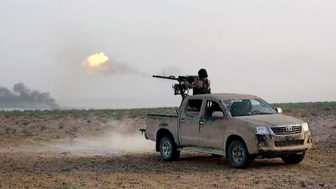In this picture released on Wednesday, May 20, 2015 by the website of Islamic State militants, an Islamic State fighter fires his weapon during a battle against Syrian government forces on a road between Homs and Palmyra, Syria. (AP)