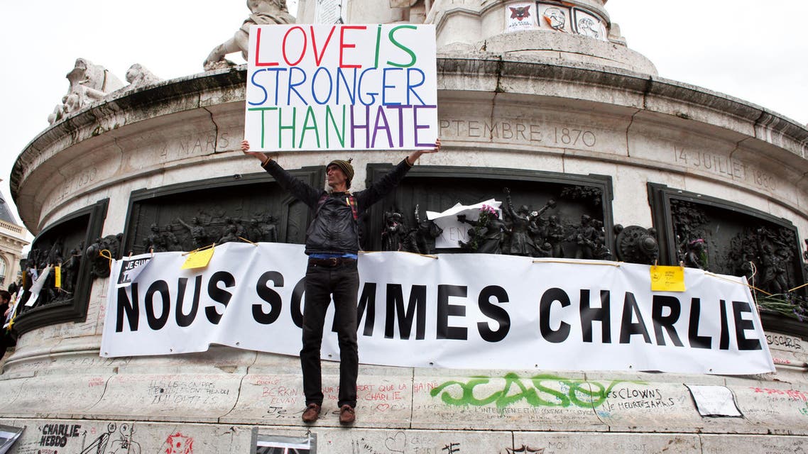 A man holds a placard during a gathering three months after the terror attack against French satirical newspaper Charlie Hebdo, at the Place de la Republique, in Paris, Saturday, April 11, 2015. (AP)