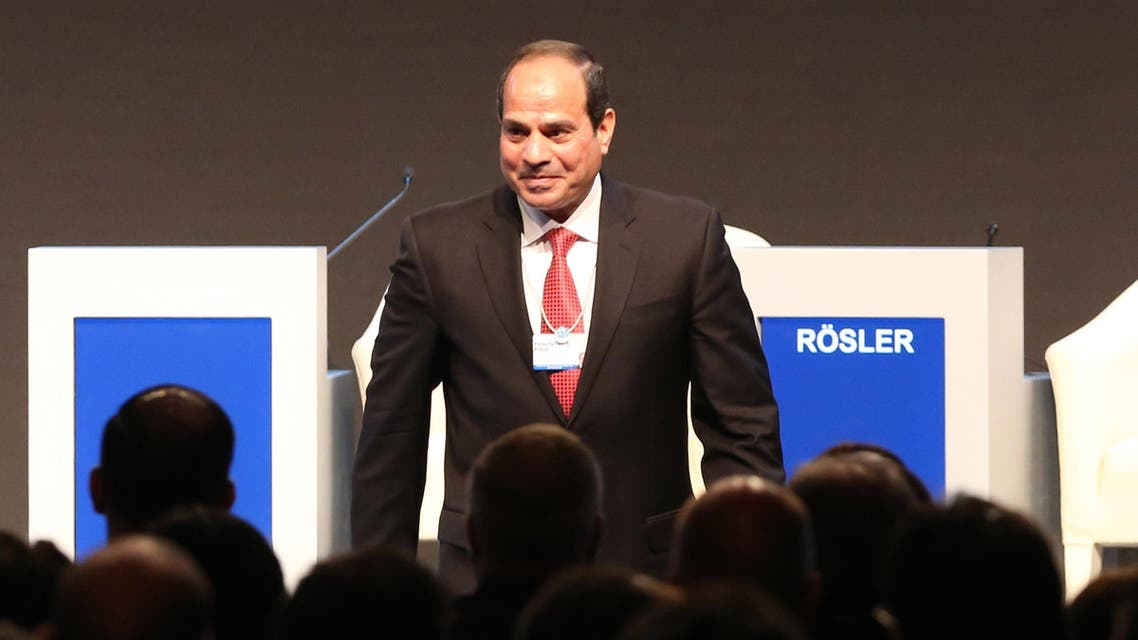 Egyptian President Abdel Fattah al-Sisi stands on stage on the opening day of the World Economic Forum on the Middle East and North Africa 2015 on May 22, 2015 in the Dead Sea resort of Shuneh, west of the capital Jordanian Amman. AFP PHOTO / KHALIL MAZRAAWI
