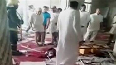 People are seen looking at debris scattered around the floor of a mosque in Al-Qadeeh, Saudi Arabia in this May 22, 2015 still image taken from video courtesy of Abo Kadi Al Numer. (Reuters)