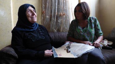  Journalist Nabila Ramdani with Fatma Hussein Omar, 67, showing the key and the legal documents to her home confiscated by Israel's Zionist paramilitaries in 1948 - hoping to return there. (Al Arabiya/ Nabila Ramdani)
