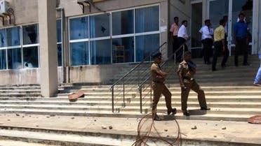 Sri Lanka police stand outside a court in Jaffna after violent protests shook the district (Photo courtesy of Twitter)