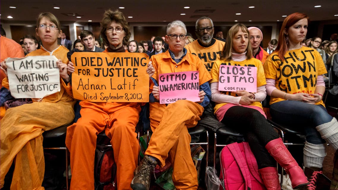 Activists from the antiwar group CodePink hold silent protest at the Senate Armed Services Committee during a hearing on the detention center in Guantanamo, Cuba, on Capitol Hill in Washington, Thursday, Feb. 5, 2015. AP