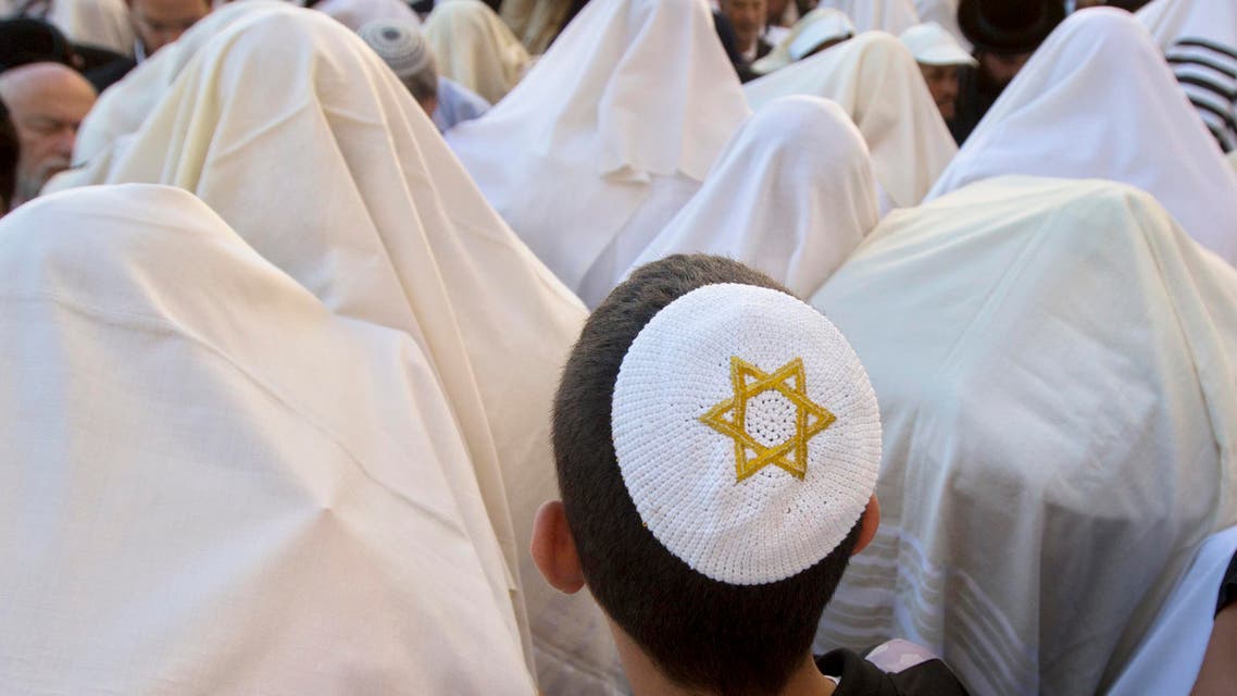 Covered in prayer shawls, Israeli ultra-Orthodox Jewish men of the Cohanim Priestly caste participate in a blessing during the Jewish holiday of Passover, in front of the Western Wall, the holiest site where Jews can pray in Jerusalem's old city, Monday, April 6, 2015. (AP)