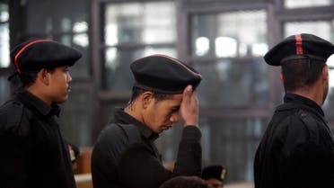 Egyptian soldiers line up to secure the court cell during the verdict hearing of 21 people including prominent activists over an unauthorized street protest in 2013, at a Cairo court, Egypt, Monday, Feb. 23, 2015. An Egyptian court sentenced Alaa Abd el-Fattah, an icon of the country's 2011 revolt to five years in prison Monday, showing authorities' determination to continue to stifle dissent despite promises by its president to release "wrongly jailed youths." Another defendant, Ahmed Abdel Rahman, was also given five years. The others were sentenced to three years. (AP Photo/Amr Nabil)