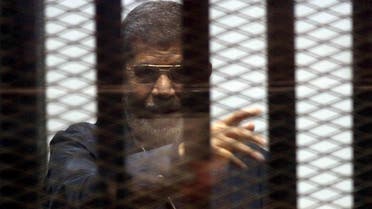 Ousted Egyptian President Mohamed Mursi is seen behind bars during his trial at a court in Cairo, April 30, 2015. (Reuters)