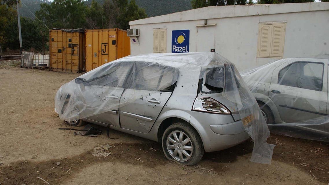 A car that was the target of a bombing, killing a French engineer working on a renovation project for a French enterprise is seen under a plastic cover in the town of Beni Amrane, Algeria, Monday, June 9, 2008. AP