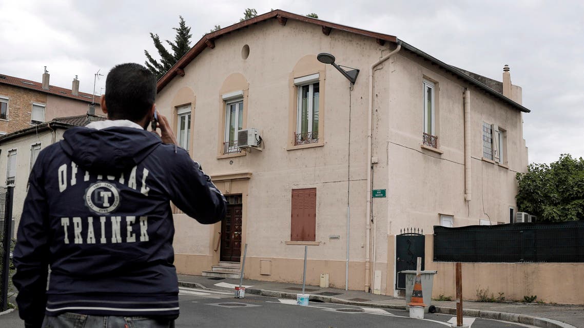 In this photo dated Tuesday, May 26, 2015 a man makes a phone call as he walk past a mosque in Oullins outside Lyon, central France. The small Oullins mosque on the edge of Lyon won an unusual court battle on Wednesday against an ultraconservative Salafist member of the congregation regarded as disruptive and, in an apparent first for Muslims, used France’s 1905 law guaranteeing secularism to argue its case.(AP Photo/Laurent Cipriani)