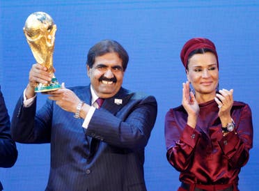 Sheikh Hamad bin Khalifa Al-Thani, Emir of Qatar, left, and Sheika Mozah bint Nasser al-Misned hold the World Cup trophy after the announcement of Qatar hosting the 2022 soccer World Cup in Zurich, Switzerland, Thursday, Dec. 2, 2010. (AP)