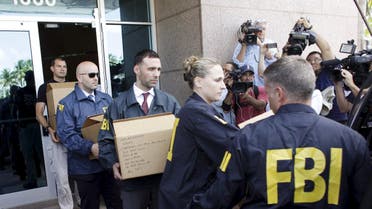 FBI agents bring out boxes after an operation inside the CONCACAF (Confederation of North, Central America and Caribbean Association Football) offices in Miami Beach, Florida May 27, 2015. (Reuters)