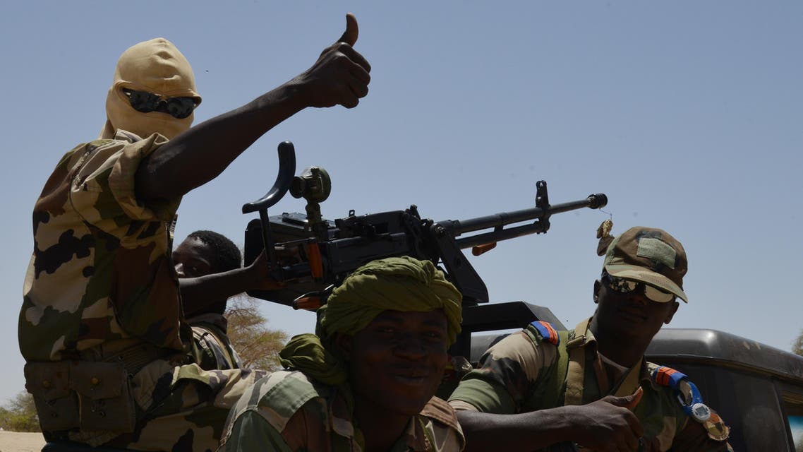 Nigerien soldiers patrol in Bosso, near the Nigerian border, on May 25, 2015. Niger has extended for three months the state of emergency in its southeastern Diffa region where the army has been battling Boko Haram militants since February, authorities announced on May 27, 2015. The operation, nicknamed Barkhane, which succedeed to Serval one, is taking place across Mauritania, Mali, Burkina Faso, Niger and Chad and involves a total 3,000 French troops. AFP PHOTO / ISSOUF SANOGO