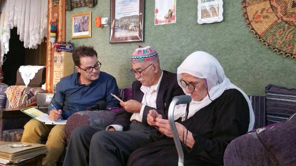 Researcher from the Palestinian Museum sitting with the Jamal Yousef Bek Ali family.
