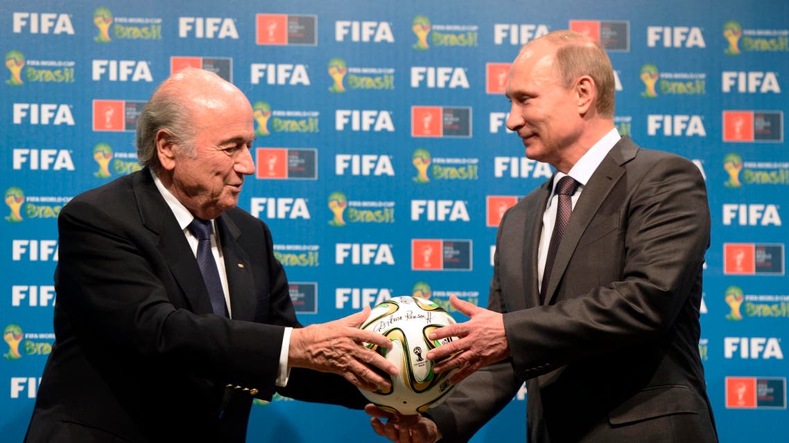 n this file photo taken on Sunday, July 13, 2014, FIFA President Sepp Blatter, left, and Russian President Vladimir Putin hold a soccer ball - AP