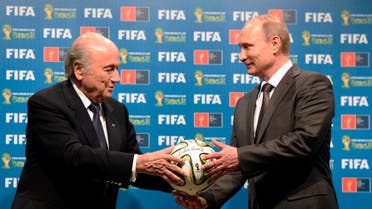 n this file photo taken on Sunday, July 13, 2014, FIFA President Sepp Blatter, left, and Russian President Vladimir Putin hold a soccer ball - AP 