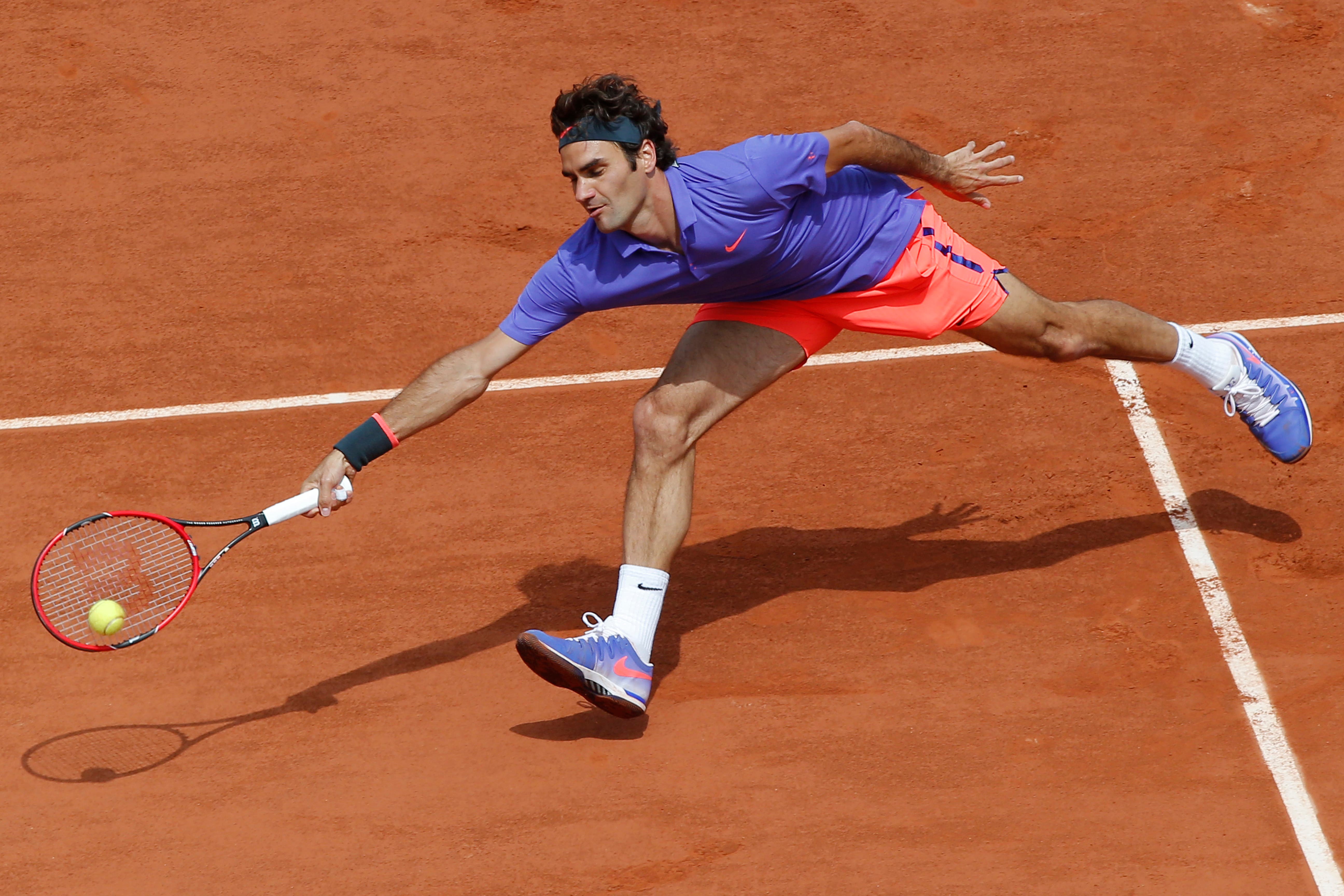 Switzerland's Roger Federer returns in the third round match of the French Open tennis tournament against Bosnia and Herzegovina's Damir Dzumhur at the Roland Garros stadium, in Paris, France, Friday, May 29, 2015.  (AP)