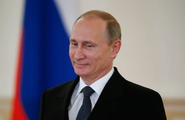 Russian President Vladimir Putin attends a ceremony of presentation of credentials by foreign ambassadors in the Kremlin in Moscow, Russia, Thursday, May 28, 2015. President Vladimir Putin accused the United States of meddling in FIFA's affairs and hinted that it was part of an attempt to take the 2018 World Cup away from his country. (Sergei Karpukhin/Pool Photo via AP)