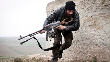 A Free Syrian Army fighter takes cover during fighting with the Syrian Army in Azaz, Syria. (AP) 