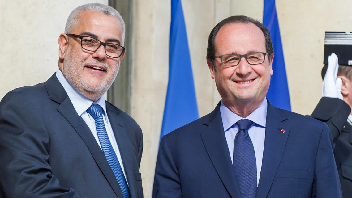 France's President Francois Hollande, right, welcomes Morocco's Prime Minister Abdelilah Benkirane prior to their meeting at the Elysee Palace in Paris, France, Wednesday, May 29, 2015. (AP Photo/Kamil Zihnioglu)