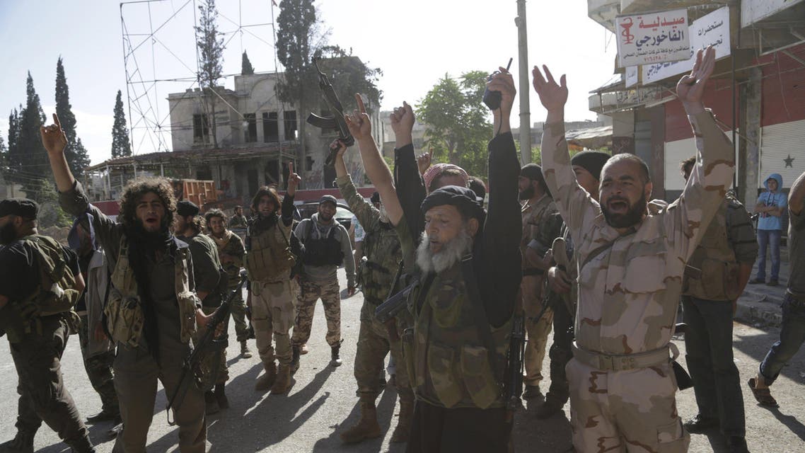 Members of al Qaeda's Nusra Front gesture as they cheer in the northwestern city of Ariha, after a coalition of insurgent groups seized the area in Idlib province May 29, 2015. A Syrian insurgent alliance which has captured the last government-held town in the northwestern Idlib province made further advances on Friday, a monitoring group and fighters said. REUTERS/Khalil Ashawi