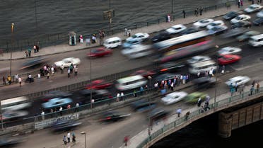 Egyptians wait for the bus on a bridge, in Cairo, Egypt, Monday, Oct. 7, 2013. In a country where the population is around 90 million, bumper-to-bumper traffic has increased mostly in the country's capital. (AP Photo/Hassan Ammar)