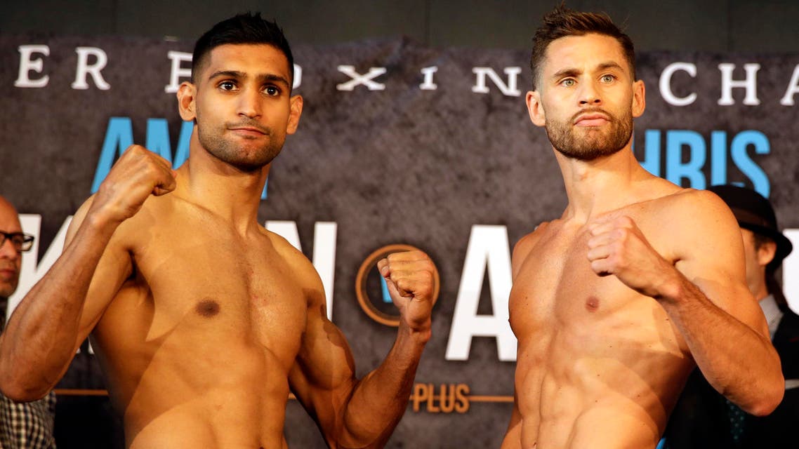 Boxers Amir Khan, left and Chris Algieri pose for photographers during their weigh-in, Thursday, May 28, 2015, in New York. AP