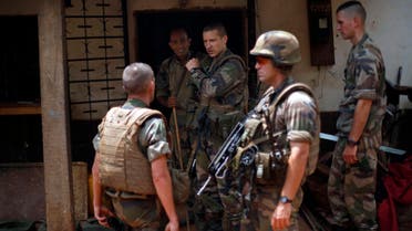 This Tuesday Feb. 11, 2014 file photo shows French soldiers searching a house used as an armed cache in the Christian sector of PK12, the last checkpoint at the exit of the town, in Bangui, Central African Republic. 