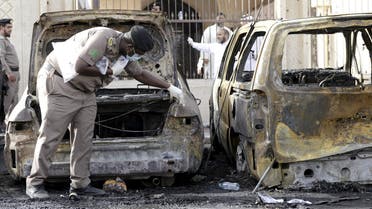 Policeman carries out an inspection after a car exploded near a Shi'ite mosque in Saudi Arabia's Dammam. (Reuters)
