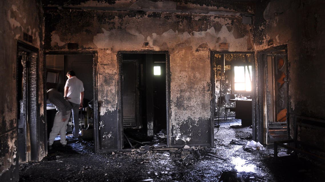 People inspect the damage in the Maysalun clinic where a fire broke out after a fuel tank exploded on May 31, 2015 in the northeastern city of Qamishli. (AFP)