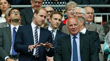 Britain's Prince William, left, gestures as he stands with FA chairman Greg Dyke after the English FA Cup final soccer match between Aston Villa and Arsenal at Wembley stadium in London, Saturday, May 30, 2015. AP