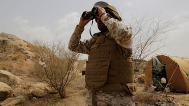 A Saudi soldier looks with binoculars toward the border with Yemen in Jazan, Saudi Arabia, Monday, April 20, 2015. The Saudi air campaign in Yemen is now in its fourth week. (AP Photo/Hasan Jamali)