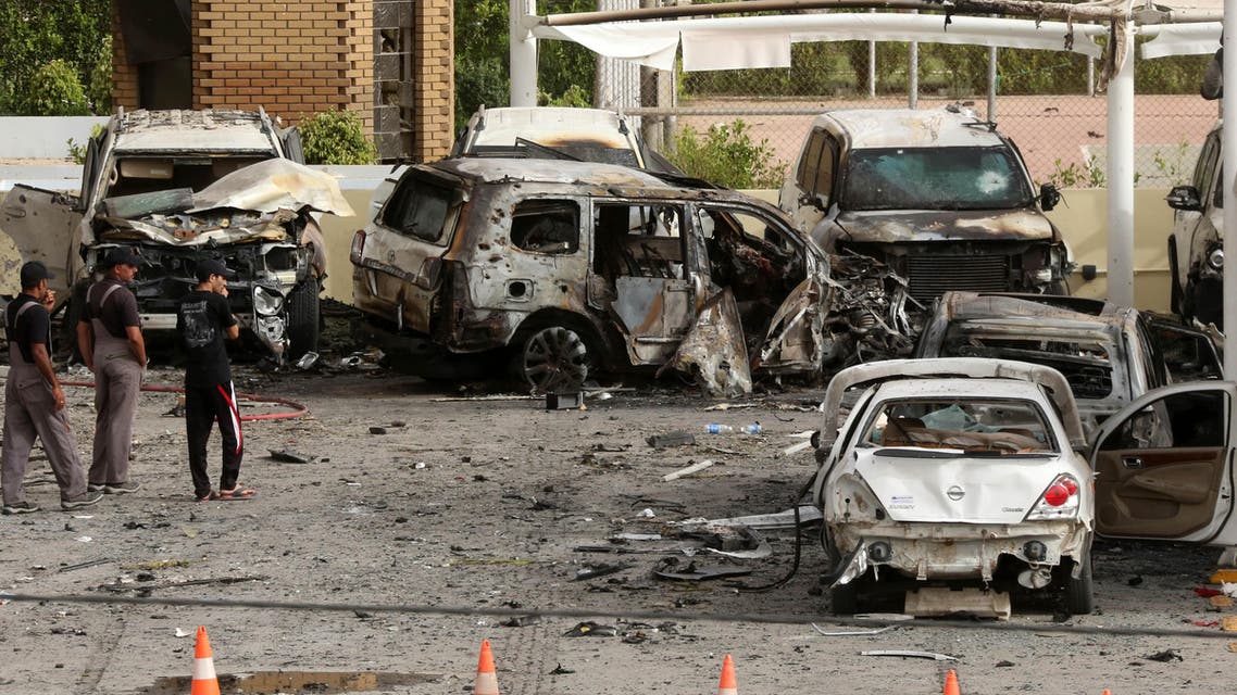 Civilians and security forces inspect the aftermath of a car bomb attack in the parking lot of Babil hotel in Karrada neighborhood, Baghdad, Iraq, Friday, May 29, 2015. Two separate car bombs inside parking lots of two downtown hotels have killed and wounded civilians late Thursday, authorities said. (AP Photo/Hadi Mizban)