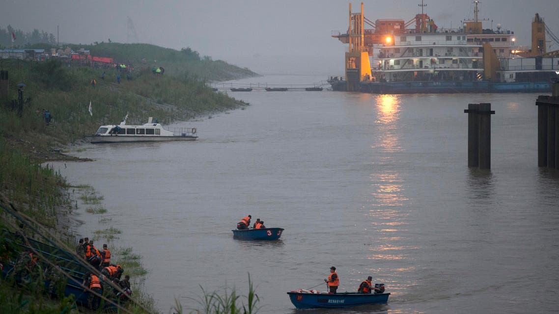 Chinese soldiers ride their boats to the embankment after their search and rescue operation near a capsized cruise ship on the Yangtze River in Jianli in central China's Hubei province, Tuesday, June 2, 2015. (AP)