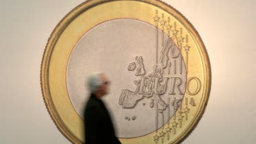 A man passes the artwork "Euro" by artist group Superflex at the art fair in Cologne, Germany, Thursday, April 16, 2015. (AP Photo/Martin Meissner)