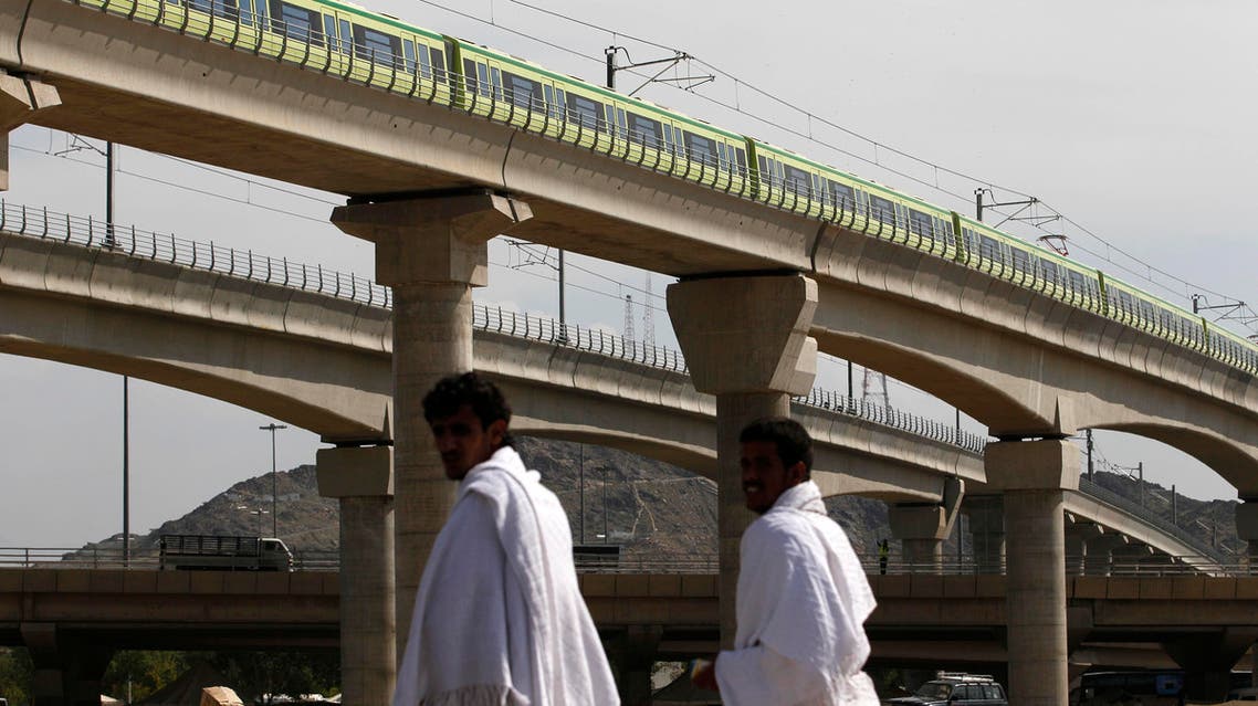 A Mecca Metro train passes over Muslim pilgrims' heads towards Mina ahead of the hajj main ritual at Mount Arafat outside Mecca, Saudi Arabia