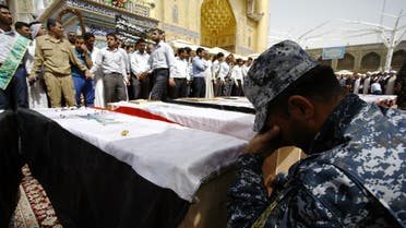  Iraqi mourners attend the funeral of members of the security forces who were killed the previous day in a suicide attack on an Iraqi police base north of Baghdad that killed at least 37 people, on June 2, 2015 in the holy Shiite city of Najaf in southern Iraq. AFP 