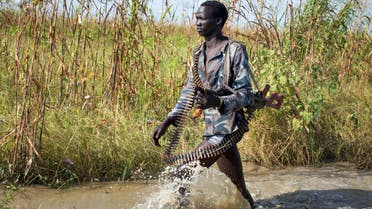 A rebel soldier patrols through a flooded area near the town of Bentiu, South Sudan Saturday, Sept. 20, 2014. Seyoum Mesfin, the chairman of the South Sudan mediation process said Saturday there is renewed fighting in South Sudan between government and rebel troops and that it is a purposeful act aimed at derailing the next phase of the peace process. (AP Photo/Matthew Abbott)