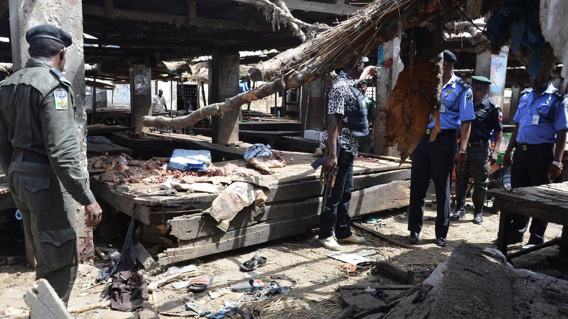 Police officers inspect the site of a suicide bomb attack at a market in Maiduguri , Nigeria, Tuesday, June 2, 2015. Boko Haram attacked the northeastern Nigerian city of Maiduguri on Tuesday with deafening explosions from the west and a suicide bombing near the center that witnesses said killed as many as 20 people. (AP Photo/Jossy Ola)
