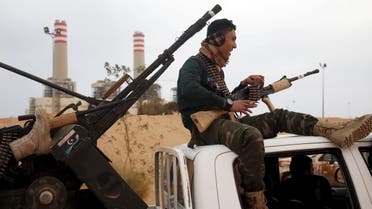A fighter from Misrata sits on top of a vehicle near Sirte, March 16, 2015. Islamic State fighters became a major force last year in Derna, a jihadi bastion in Libya's east, and quickly spread to the biggest eastern city Benghazi, where they have conducted suicide bombings on streets divided among armed factions. By occupying Sirte over the past four months they have claimed a major city in the centre of the country, astride the coastal highway that links the east and west. Picture taken March 16, 2015. REUTERS/Goran Tomasevic/File