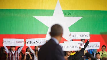Members of the audience hold up signs for U.S. President Barack Obama to see during his speech at the Young Southeast Asian Leaders Initiative town hall in Yangon, Myanmar, Friday, Nov. 14, 2014. (AP)