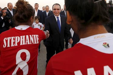 Members of the Jordanian women's national soccer team welcome Jordan's Prince Ali bin Al Hussein (C), upon his arrival at Queen Alia International Airport in Amman, after his return from participating in the International Federation of Association Football (FIFA) elections on Friday, May 31, 2015. REUTERS/ Muhammad Hamed
