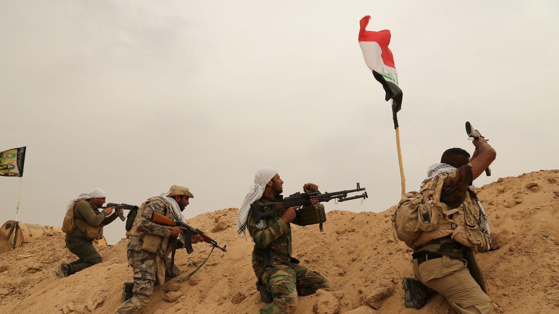 Fighters from Badr Brigades Shiite militia clash with Islamic State group militants at the front line on the outskirts of Fallujah, Anbar province, Iraq, Monday, June 1, 2015. Three Islamic State suicide bombers targeted a police base in the Tharthar area north of Ramadi, some 30 miles (48 kilometers) west of Fallujah, with explosives-laden Humvees on Monday, killing at least 41 police and Shiite militiamen, officials said. (AP Photo/Hadi Mizban)