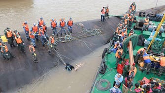 China escalates effort to recover missing from capsized ship