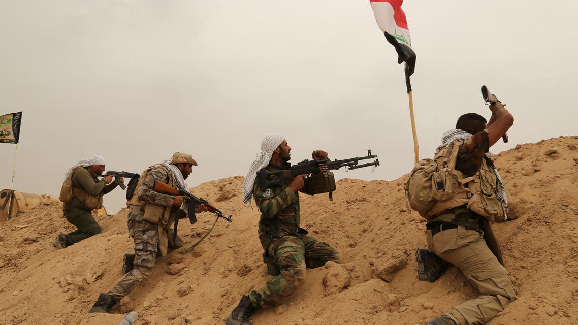 Fighters from Badr Brigades Shiite militia clash with Islamic State group militants at the front line on the outskirts of Fallujah, Anbar province, Iraq, Monday, June 1, 2015. (AP))